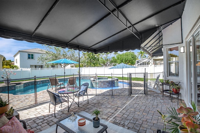 view of patio / terrace featuring a fenced backyard and a pool with connected hot tub