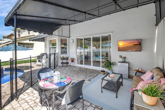 view of patio / terrace with outdoor dining area, fence, and a fenced in pool
