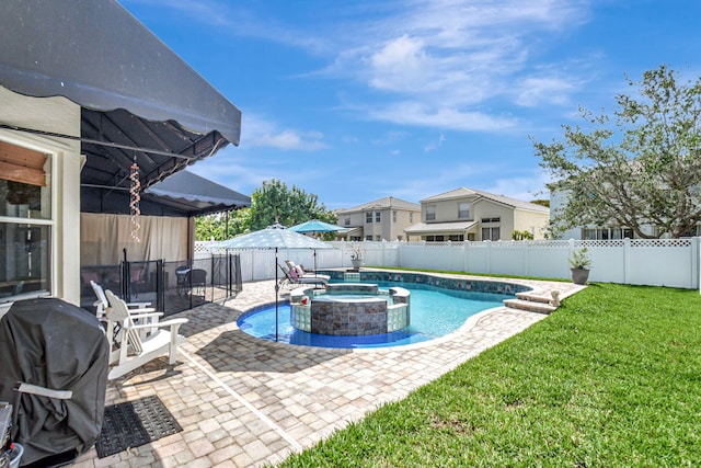 view of swimming pool featuring a pool with connected hot tub, a patio area, a grill, a fenced backyard, and a lawn