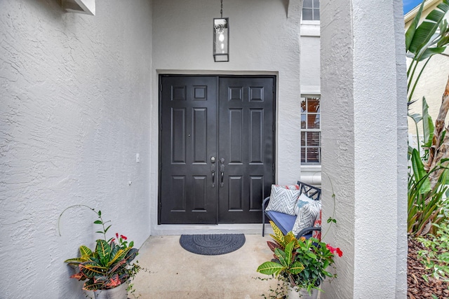 doorway to property with stucco siding