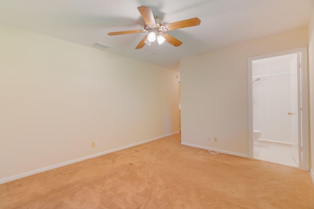 empty room with light colored carpet, ceiling fan, baseboards, and visible vents