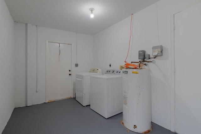 laundry room featuring washing machine and clothes dryer, water heater, and laundry area