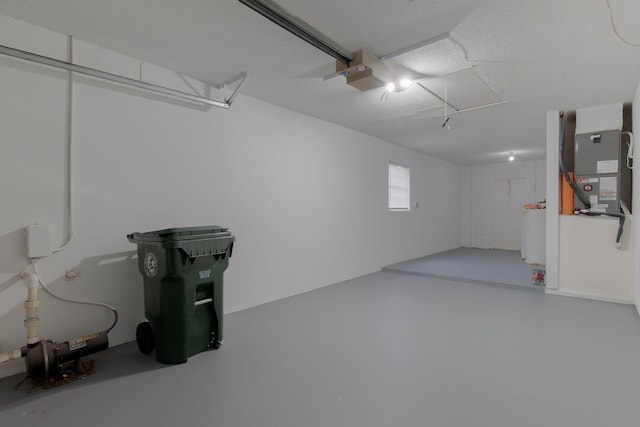 garage with a garage door opener and heating unit