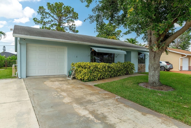 single story home featuring a garage, stucco siding, a front lawn, and concrete driveway