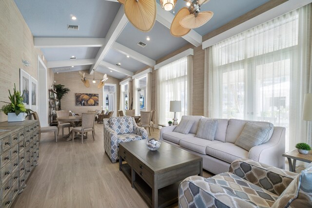 living area with an inviting chandelier, light wood-style flooring, vaulted ceiling with beams, and visible vents