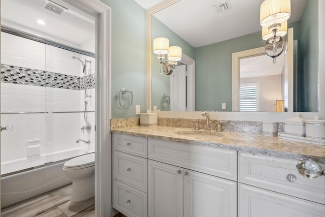 9900 S Ocean Dr Unit 1601, Jensen Beach, FL 34957 - full bathroom with shower / bath combination with glass door, visible vents, toilet, and vanity
