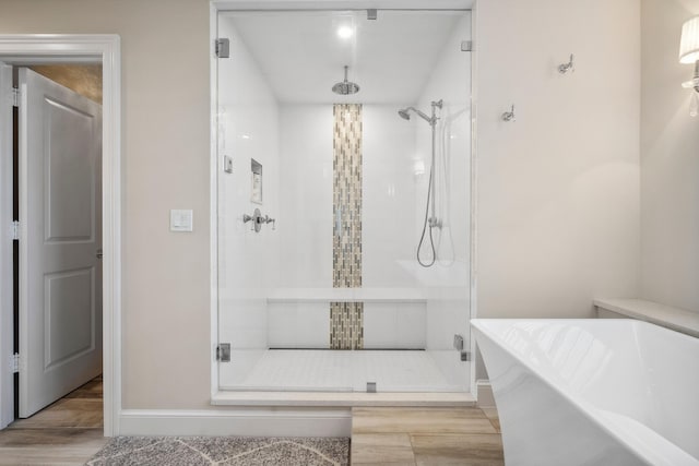 9900 S Ocean Dr Unit 1601, Jensen Beach, FL 34957 - full bath featuring a shower stall, baseboards, a soaking tub, and wood finished floors