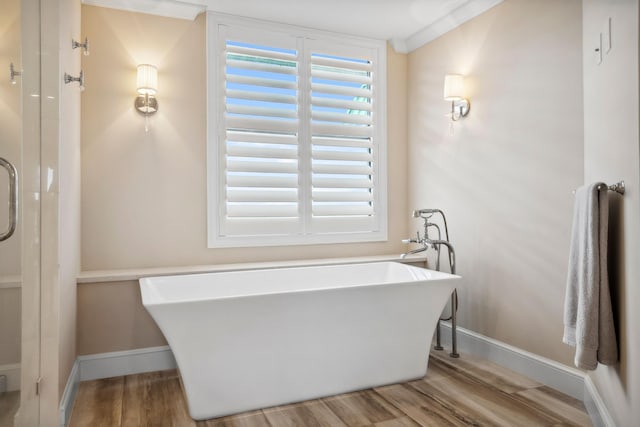 9900 S Ocean Dr Unit 1601, Jensen Beach, FL 34957 - full bath with wood finished floors, an enclosed shower, ornamental molding, baseboards, and a freestanding tub