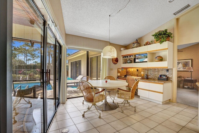 13179 Camero Way, Palm Beach Gardens, FL 33418 - dining area with a textured ceiling and light tile patterned floors