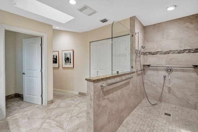 13179 Camero Way, Palm Beach Gardens, FL 33418 - full bath with a tile shower, marble finish flooring, recessed lighting, a skylight, and baseboards
