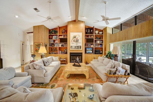 13179 Camero Way, Palm Beach Gardens, FL 33418 - living area with ceiling fan, built in features, wood walls, and a textured ceiling