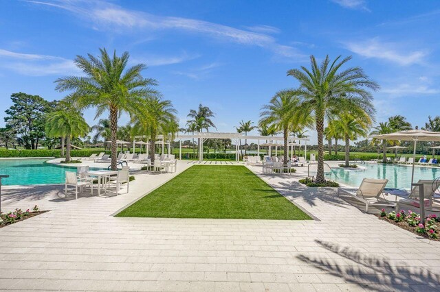13179 Camero Way, Palm Beach Gardens, FL 33418 - view of property's community with a swimming pool, a pergola, a lawn, and a patio area
