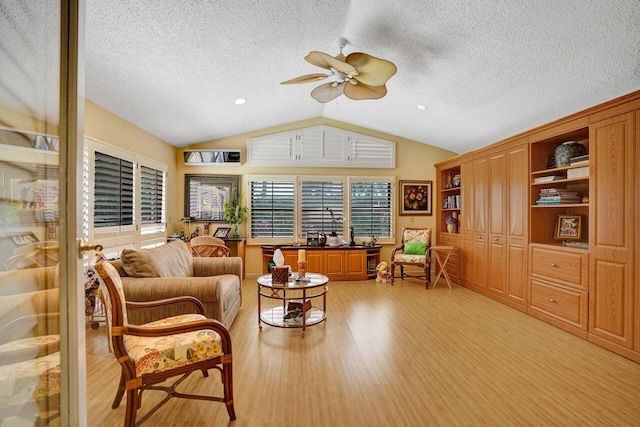 13179 Camero Way, Palm Beach Gardens, FL 33418 - living area with vaulted ceiling, ceiling fan, light wood finished floors, and a textured ceiling
