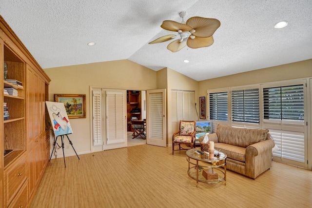 13179 Camero Way, Palm Beach Gardens, FL 33418 - living room with vaulted ceiling, a ceiling fan, a textured ceiling, baseboards, and light wood-type flooring