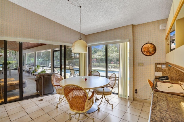 13179 Camero Way, Palm Beach Gardens, FL 33418 - dining room with light tile patterned flooring, a textured ceiling, and healthy amount of natural light