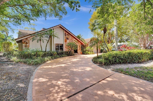 13179 Camero Way, Palm Beach Gardens, FL 33418 - view of front of house with stone siding and a tiled roof
