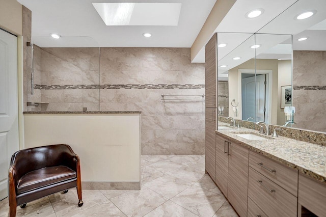 13179 Camero Way, Palm Beach Gardens, FL 33418 - full bathroom featuring vanity, a walk in shower, recessed lighting, a skylight, and tile walls