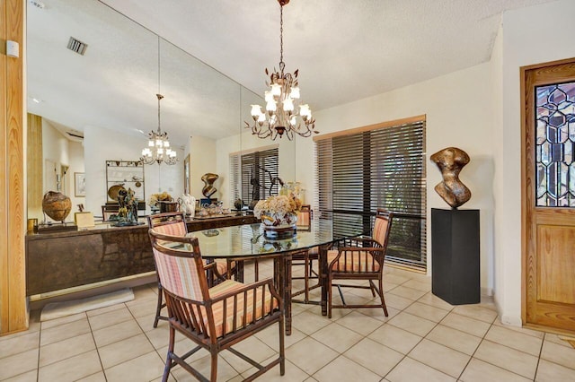 13179 Camero Way, Palm Beach Gardens, FL 33418 - dining area featuring a chandelier, light tile patterned floors, and vaulted ceiling