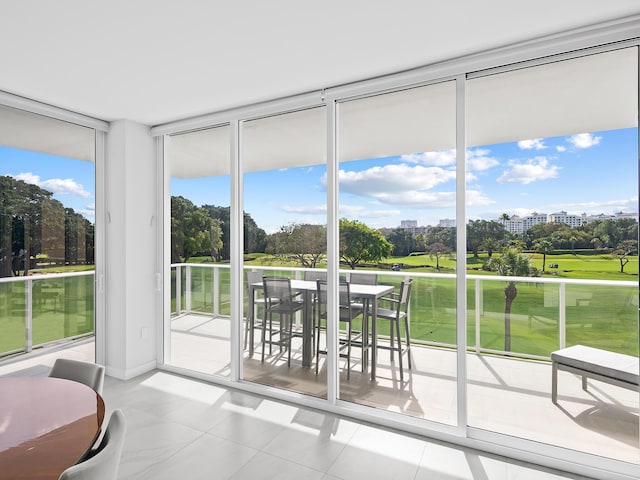 210 SE Mizner Blvd Unit 301, Boca Raton, FL 33432 - sunroom / solarium featuring a wall of windows, tile patterned flooring, and view of golf course