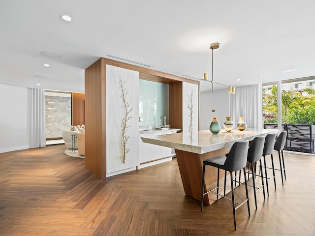 210 SE Mizner Blvd Unit 301, Boca Raton, FL 33432 - kitchen featuring light countertops, a kitchen bar, recessed lighting, healthy amount of natural light, and hanging light fixtures
