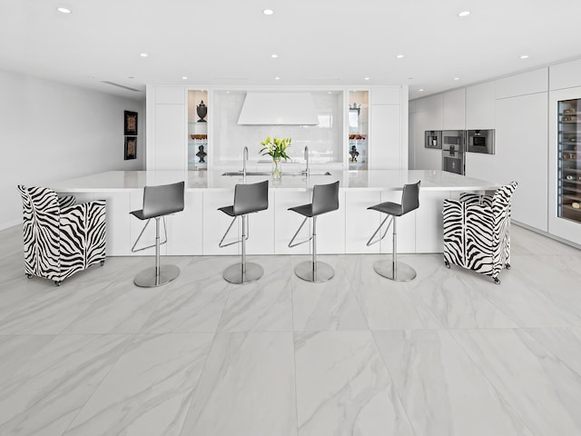 210 SE Mizner Blvd Unit 301, Boca Raton, FL 33432 - kitchen featuring modern cabinets, custom range hood, white cabinetry, light countertops, and recessed lighting