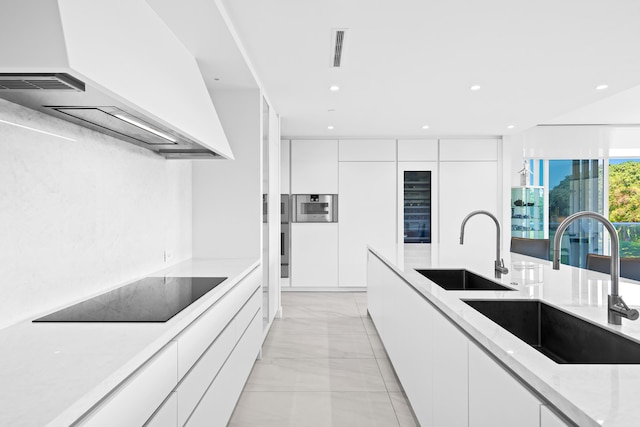 210 SE Mizner Blvd Unit 301, Boca Raton, FL 33432 - kitchen with modern cabinets, custom range hood, a sink, black electric stovetop, and recessed lighting