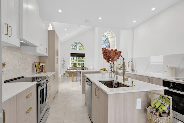 kitchen featuring a sink, recessed lighting, modern cabinets, and appliances with stainless steel finishes