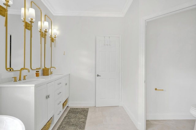 bathroom featuring double vanity, crown molding, and a sink