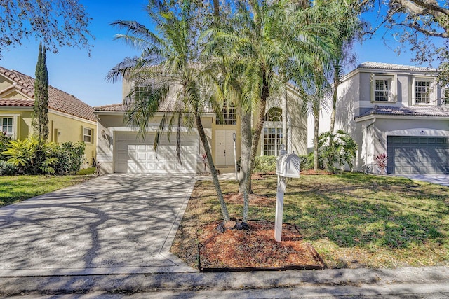 view of front of house with a tile roof, concrete driveway, and stucco siding
