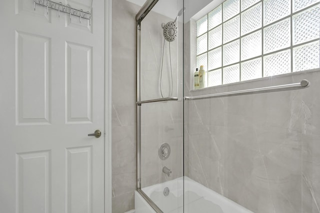 full bath featuring shower / bath combination with glass door
