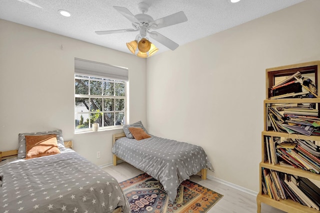 bedroom with a textured ceiling, recessed lighting, a ceiling fan, and baseboards