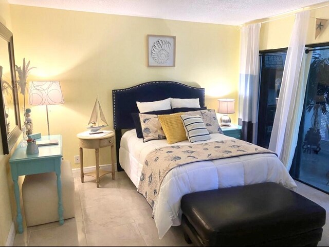 1705 Presidential Way N Unit B101, West Palm Beach, FL 33401 - tiled bedroom featuring baseboards