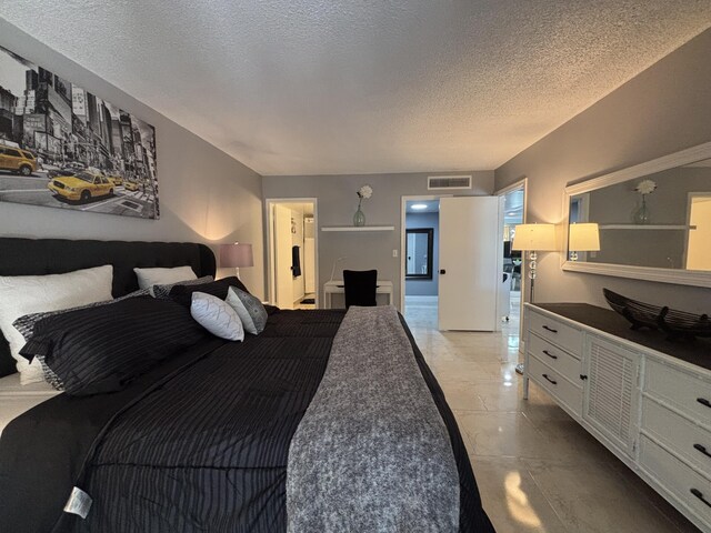 1705 Presidential Way N Unit B101, West Palm Beach, FL 33401 - bedroom featuring a textured ceiling