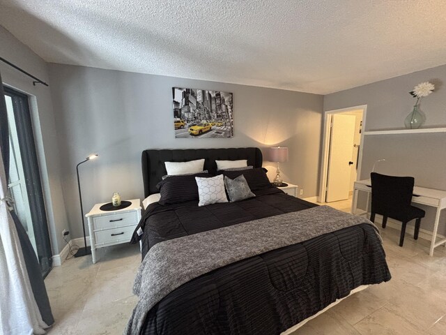 1705 Presidential Way N Unit B101, West Palm Beach, FL 33401 - bedroom with a textured ceiling and baseboards