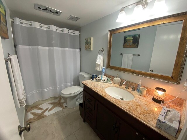 1705 Presidential Way N Unit B101, West Palm Beach, FL 33401 - bathroom featuring toilet, vanity, and curtained shower