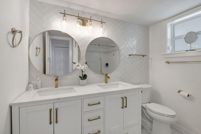 full bath featuring a sink, toilet, a tile shower, and marble finish floor