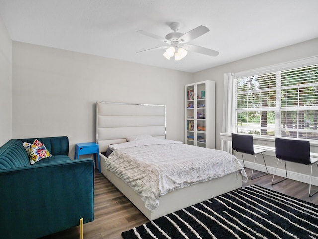 17411 N 40th Run, Loxahatchee, FL 33470 - bedroom featuring wood finished floors, a desk, baseboards, and a ceiling fan