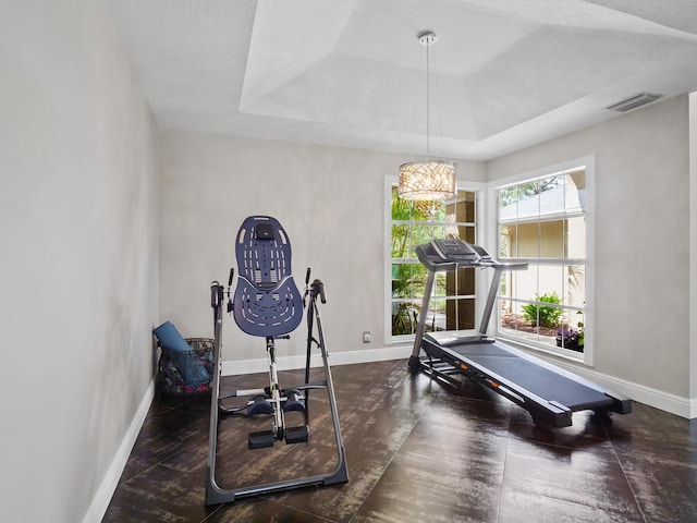 17411 N 40th Run, Loxahatchee, FL 33470 - workout area featuring baseboards, a tray ceiling, wood finished floors, and a chandelier