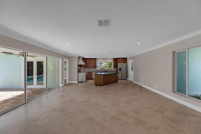 unfurnished living room featuring crown molding, baseboards, and visible vents