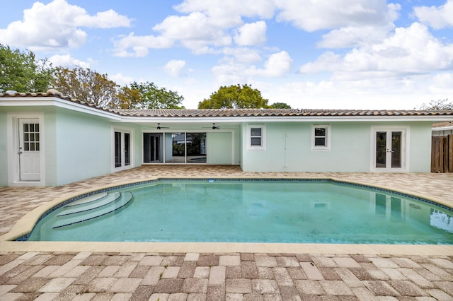 outdoor pool featuring a patio area, french doors, and ceiling fan
