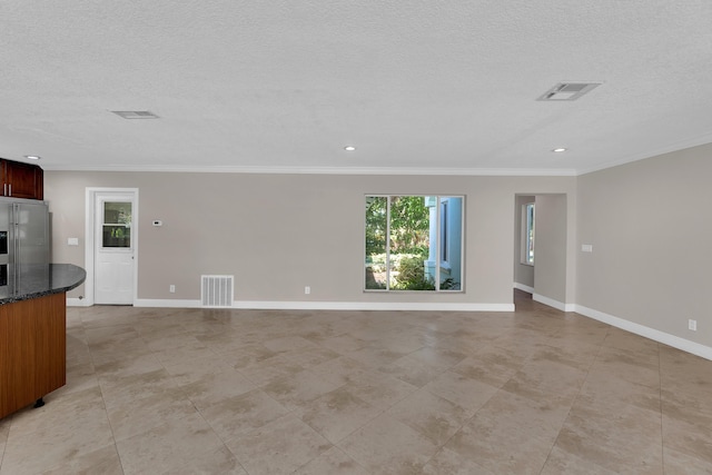unfurnished living room featuring ornamental molding, visible vents, and a textured ceiling