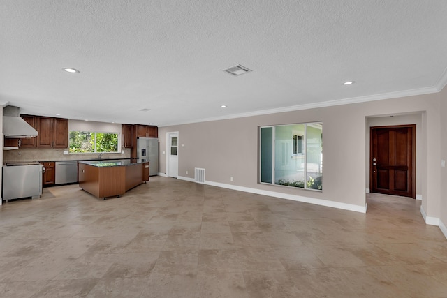 unfurnished living room with ornamental molding, a textured ceiling, baseboards, and visible vents