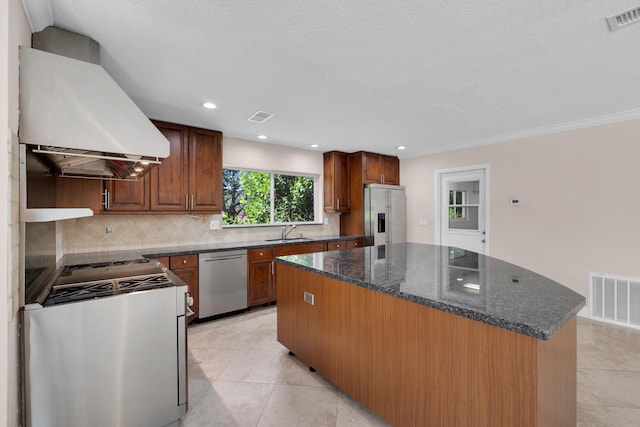 kitchen featuring a sink, extractor fan, stainless steel appliances, and visible vents