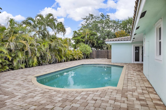 view of swimming pool featuring fence, a patio, and a fenced in pool