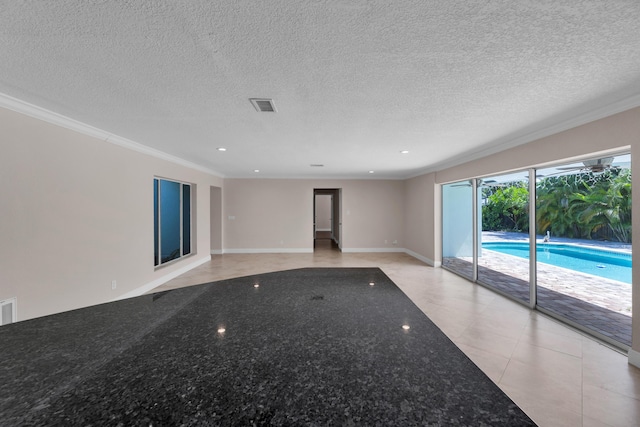 empty room with ornamental molding, baseboards, visible vents, and recessed lighting