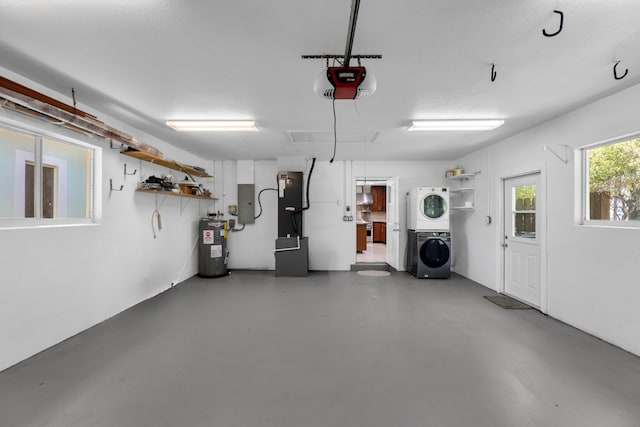 garage featuring stacked washer and dryer, water heater, and a garage door opener
