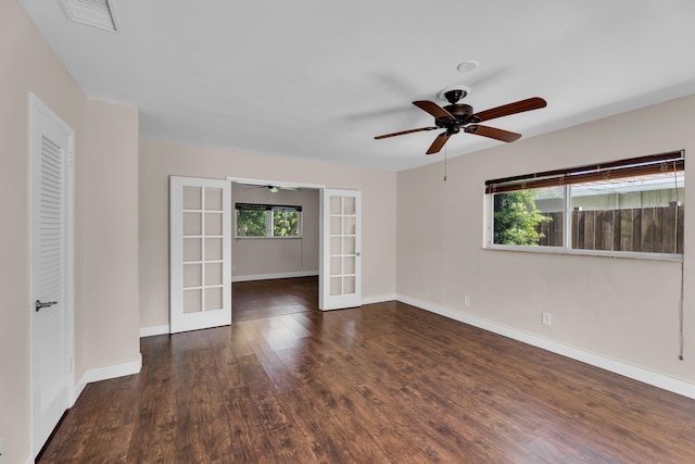 unfurnished room with wood finished floors, french doors, visible vents, baseboards, and ceiling fan