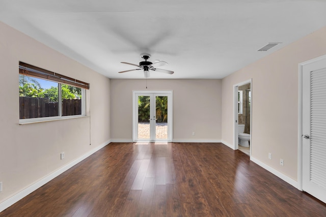 spare room featuring french doors, wood finished floors, visible vents, a ceiling fan, and baseboards