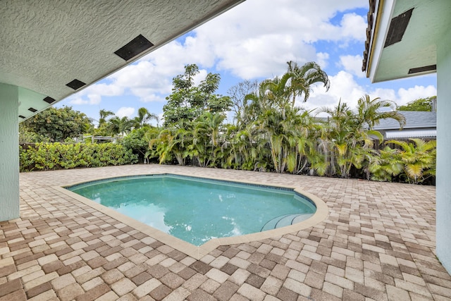 outdoor pool featuring a patio area