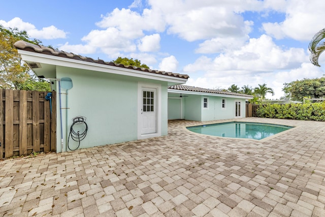 view of swimming pool with a patio area, fence, a ceiling fan, and a fenced in pool